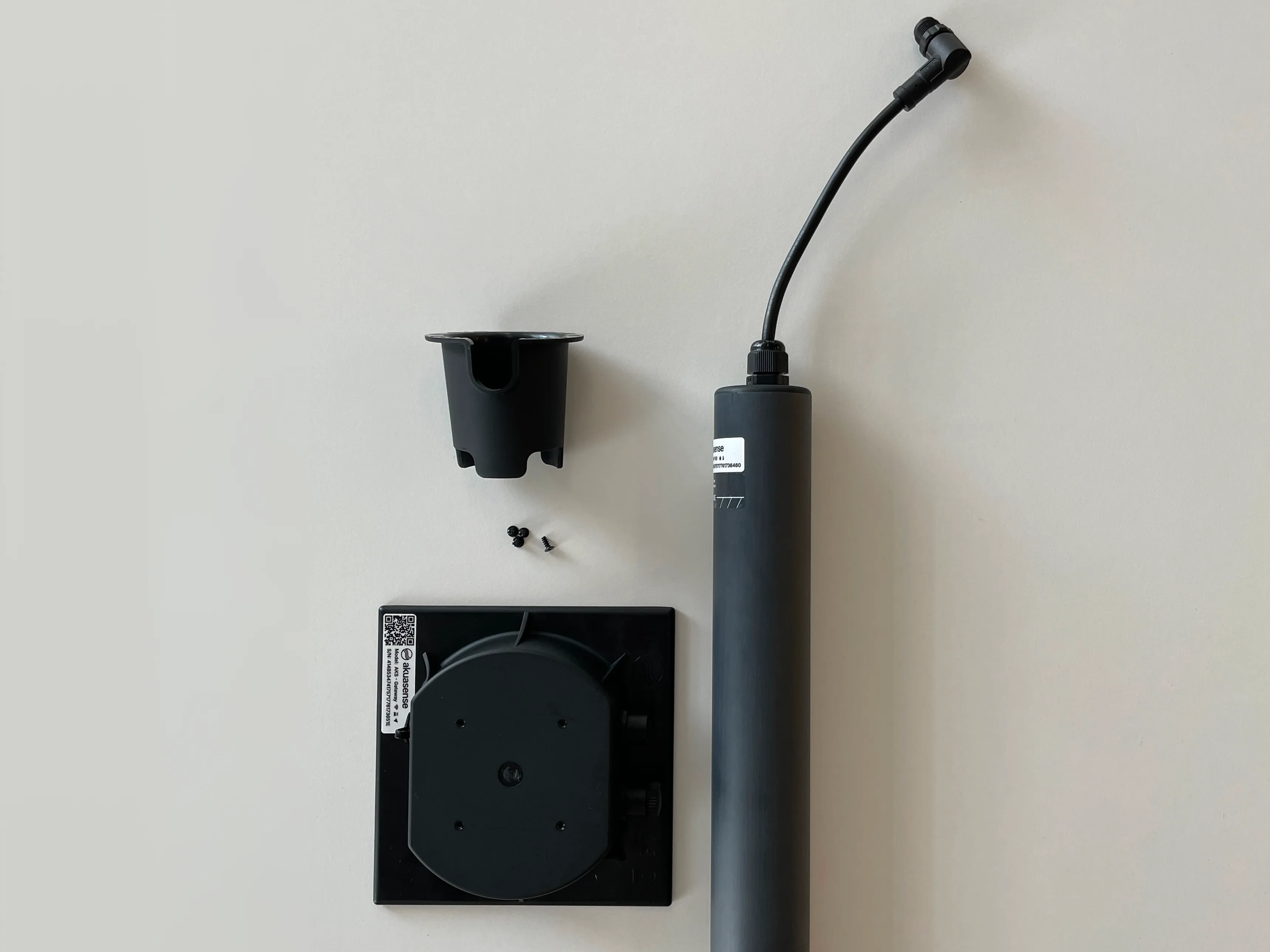 Unboxed package contents: probe, device, bracket and screws